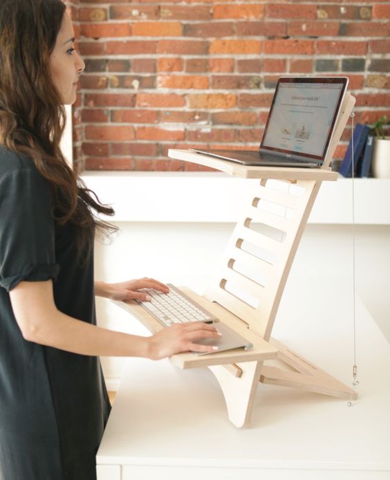 a simple and minimalist wooden stand desk is a cool and mobile piece to use at home and in any other space