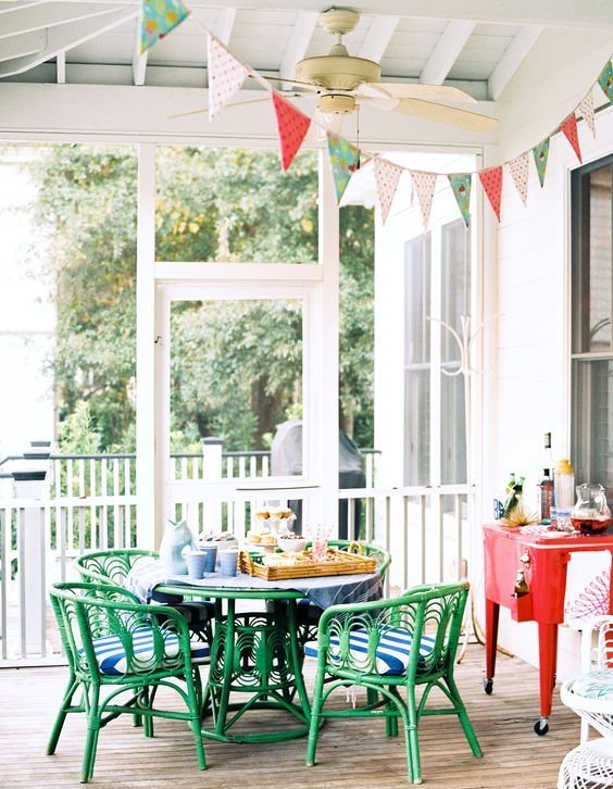a bright green dining wicker set with striped cushions and a coral drink station