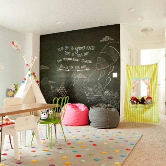 a colorful kids' playroom with a couple of bean bag chairs - a grey and a coral one for fun