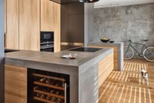 06 a minimalist industrial kitchen of light-colored wood with concrete countertops plus metal touches