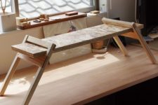 06 a small adjustable wooden desk can be placed on a usual one and removed when not in need