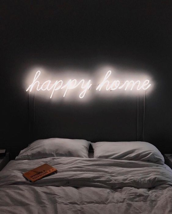 illuminate your bed with a neon light sig instead of a headboard to make it more welcoming