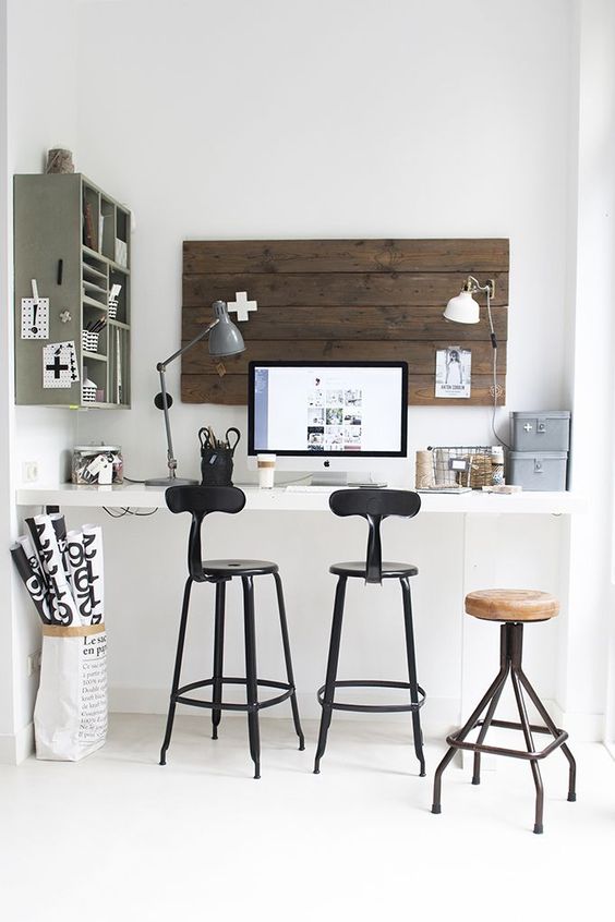 a built-in wall-mounted desk with high stools to sit or stand whenever you want