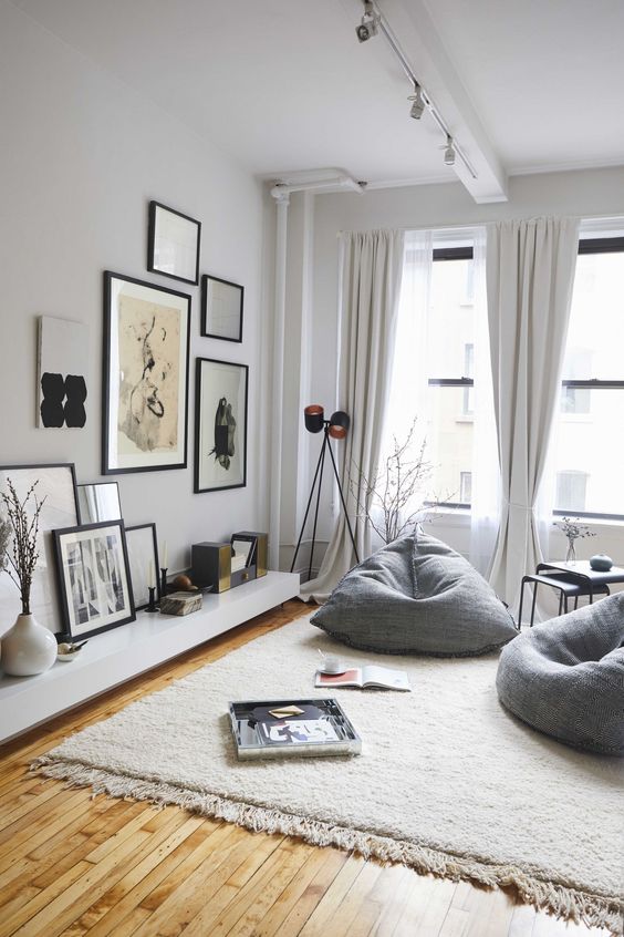 a couple of grey bean bag chairs is used instead of usual chairs to create a comfy nook