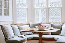 07 a cozy built-in chalf circle banquette seating with a small rustic table look very inviting