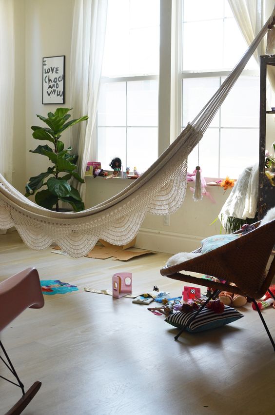 a kid's play space with a beautiful hammock for relaxing - such a solution doesn't take any floor space