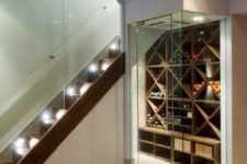 07 a modern wine cellar with glass walls and doors plus a large shelving unit for bottles