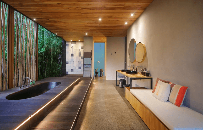 Here's a spa bathroom with a large sunken tub, which is opened to outdoors, yet hidden with a bamboo wall