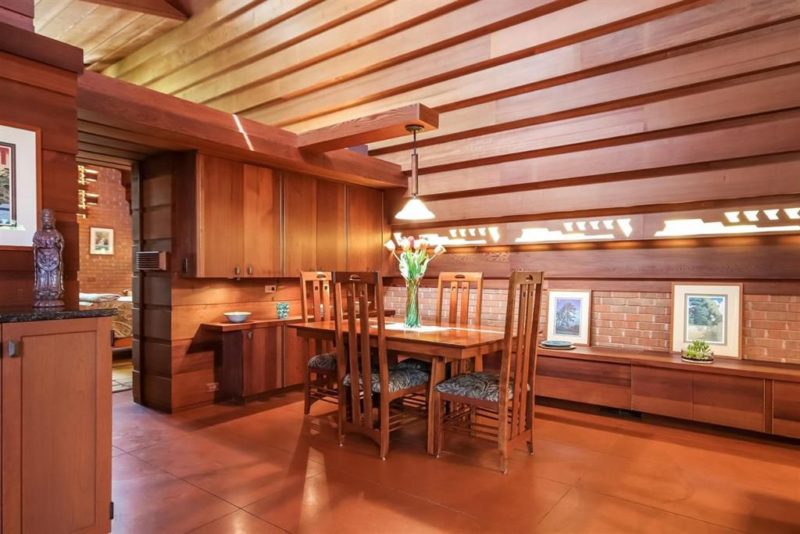 The dining space features some cabinets of redwood and a small dining set
