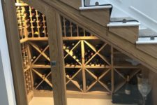 08 a small wine cellar with glass doors and wooden shelves for storage doesn’t require much space
