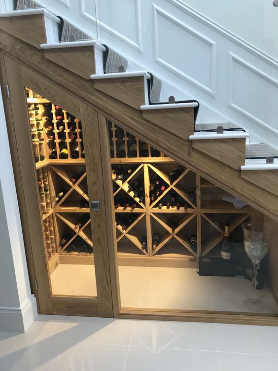 a small wine cellar with glass doors and wooden shelves for storage doesn't require much space