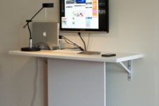 08 a tiny wall-mounted desk with hidden cables can accommodate a laptop or a wall-mounted screen
