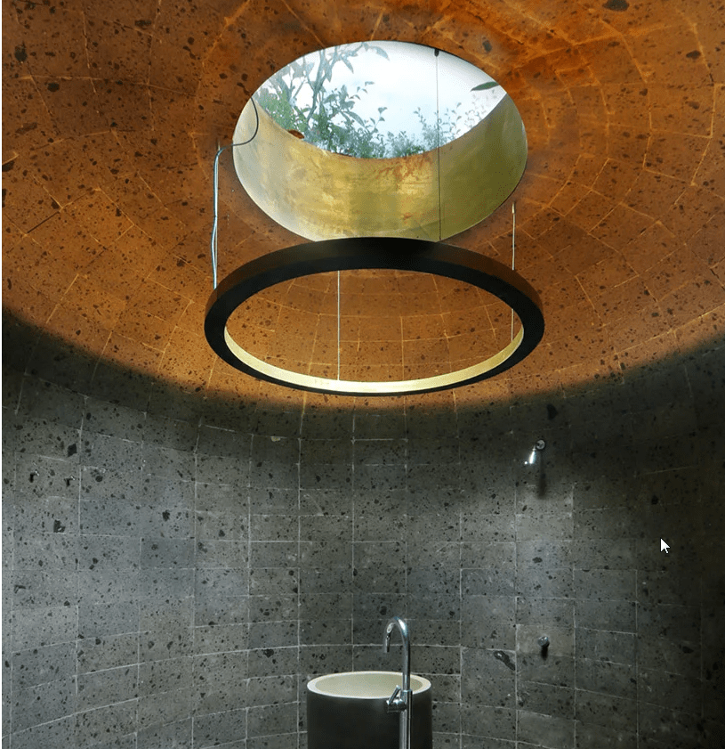 A powder room features a unique ceiling with a hanging structure to highlight it