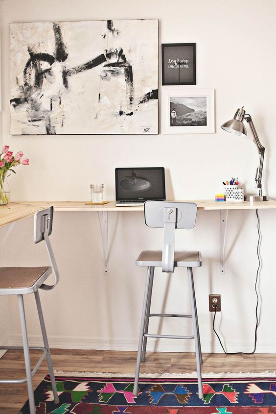a simple wall-mounted double desk with tall stools is a nice idea that looks lightweight