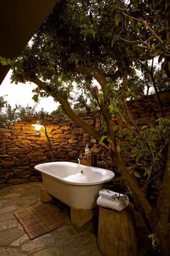 A stone wall brings the desired privacy while making the outdoor space more natural looking