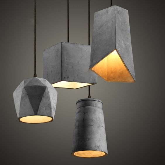 an arrangement of sculptural concrete pendant lamps that make a bold statement