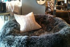 10 a faux sheep skin bean bag chair with a pillow cna be used both as a chair or as a lounger