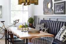 10 a modern dining area with a black leather banquette and a raw edge dining table