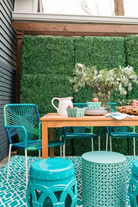 a neutral wooden table and bright turquoise string covered chairs for a modern space