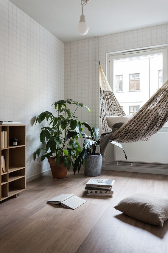 a serene contemporary space is softened and made more relaxed with a hammock