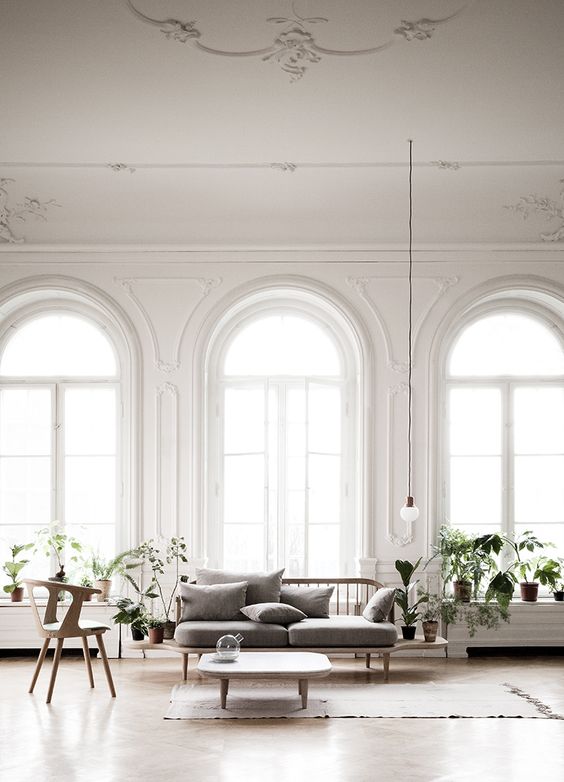 arched floor to ceiling windows create a refined and chic feeling in the space