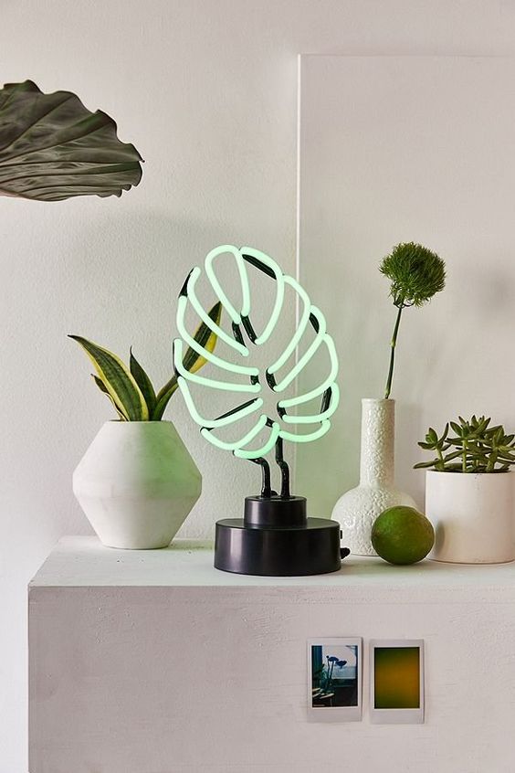 a monstera leaf neon tale lamp won't wither and will spruce up your space making it whimsy and cool