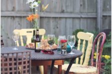 11 a rounf wicker table and all-mismatching chairs, shabby and rustic ones in different colors