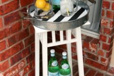 11 a small bar cart made of an IKEa plant stand and a metal tray is ideal for a tiny outdoor space