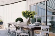 12 a rough wooden table and white refined and elegant forged chairs for a stylish statement