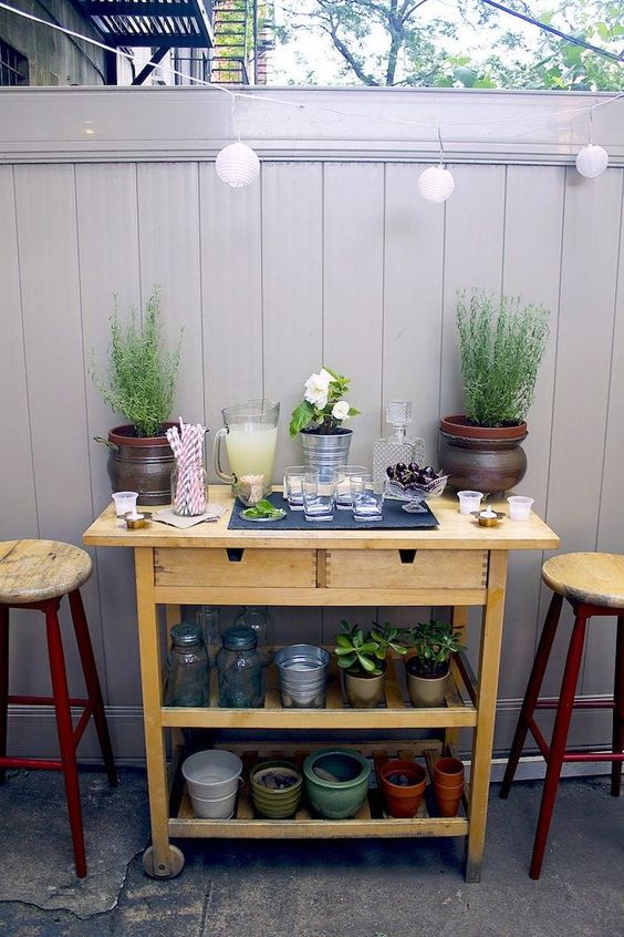 a simple outdoor bar made of an IKEA Forhoja cart painted in a neutral color - such an easy hack doesn't require much skill