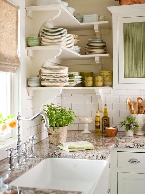 a white rustic kitchen with brown granite countertops and a tile backsplash for a chic look