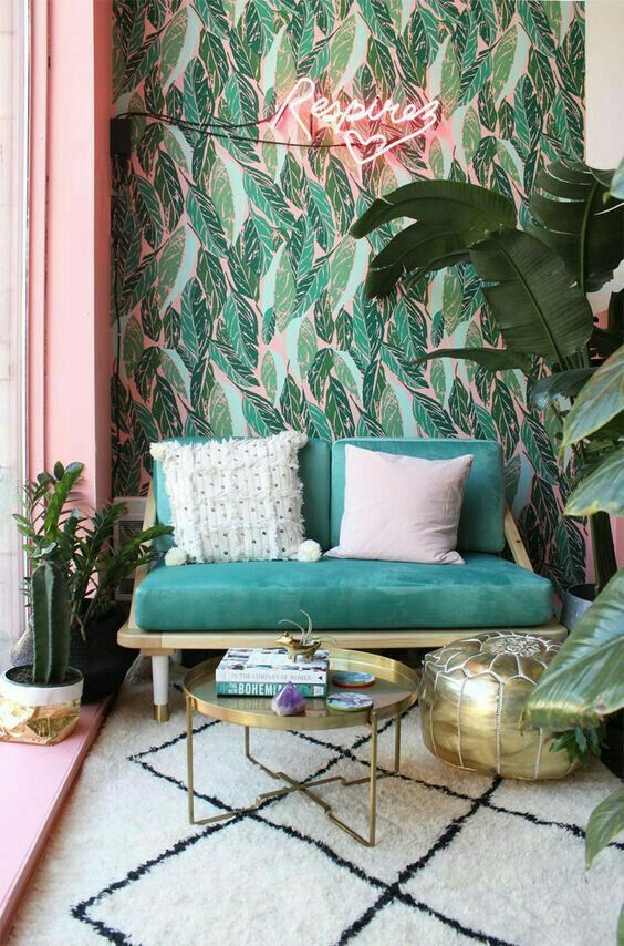 Neon lights are ideal for tropical spaces like this one   green and pink wallpaper is complemented with tropical plants and a pink neon light