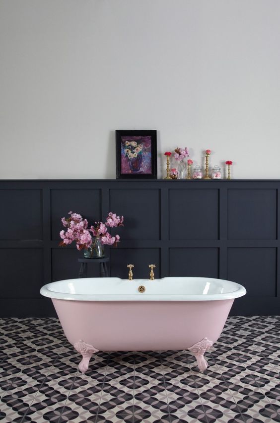 a dusty rose bathtub in a monochromatic space adds a soft girlish feel