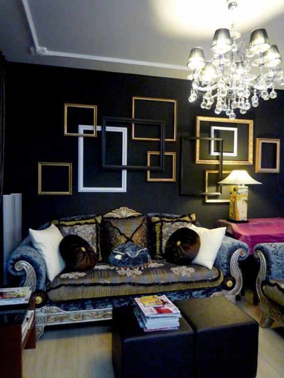 a moody refined space highlighted with an arrangement of frames in black, white and gold