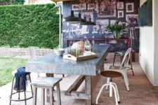 14 an industrial dining space with a metal covered table and all different chairs from industrial to rustic