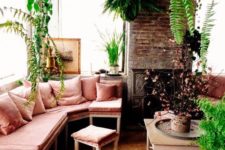 15 a neutral sunroom filled wiht a lot of potted greenery and with a corner bench in dusty rose