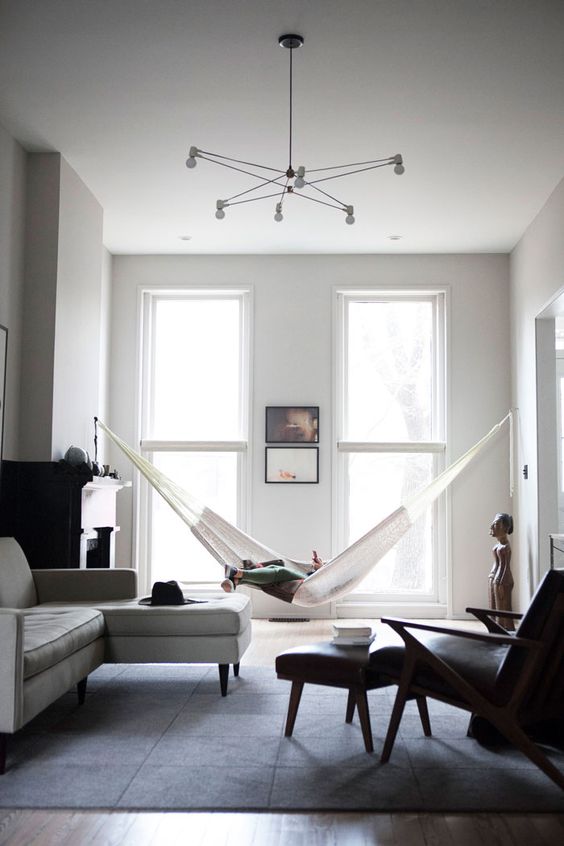 a rather formal space is spruced up with a hammock and made more relaxed