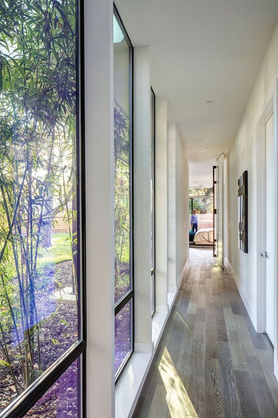 illuminate your corridor with several floor to ceiling windows to make it visually larger