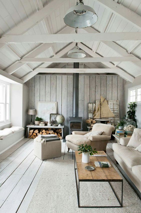 refreshing coastal  room is done with a grey plank wall and floor for a washed out coastal feel