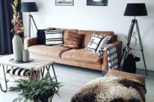 16 a brown leather ottoman of a large size and a matching sofa make the space cool