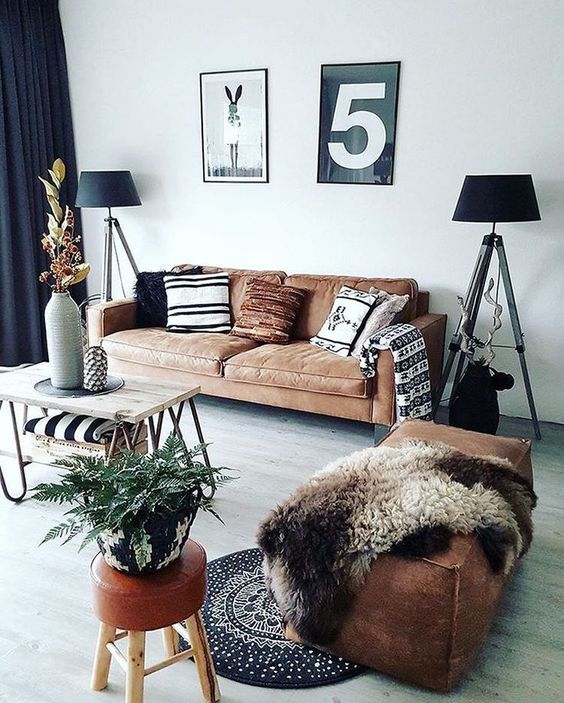 a brown leather ottoman of a large size and a matching sofa make the space cool