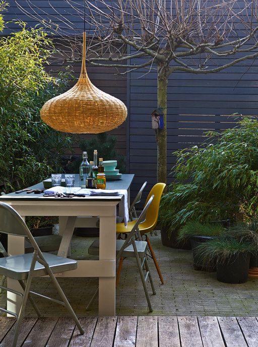 a modern dining space is made cooler and cozier with a catchy wicker lampshade