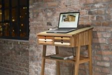 16 a small wooden standing desk with little colorful drawers is suitable for a laptop