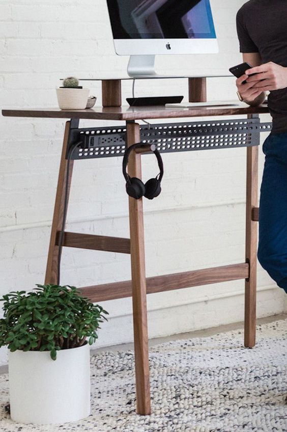 a stylish contemporary standing desk of wood and blackened steel won't spoil your space