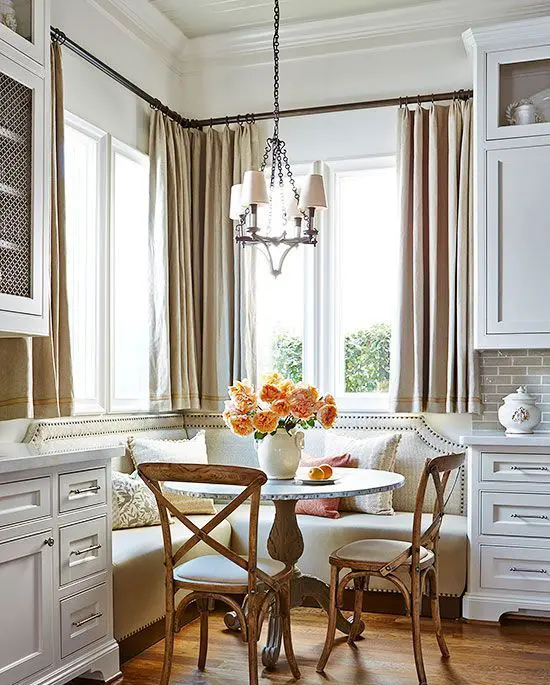 a traditional space with a vintage feel and a corner banquette seating with a nail trim