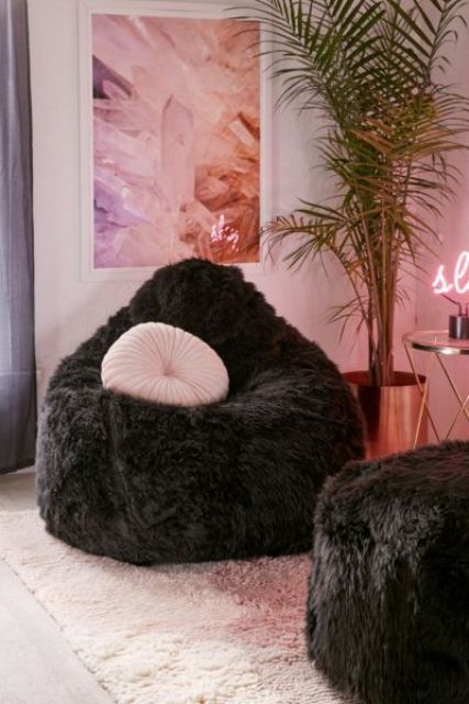 make your conversation space more glam with two fluffy bean bag chairs in black and pink pillows