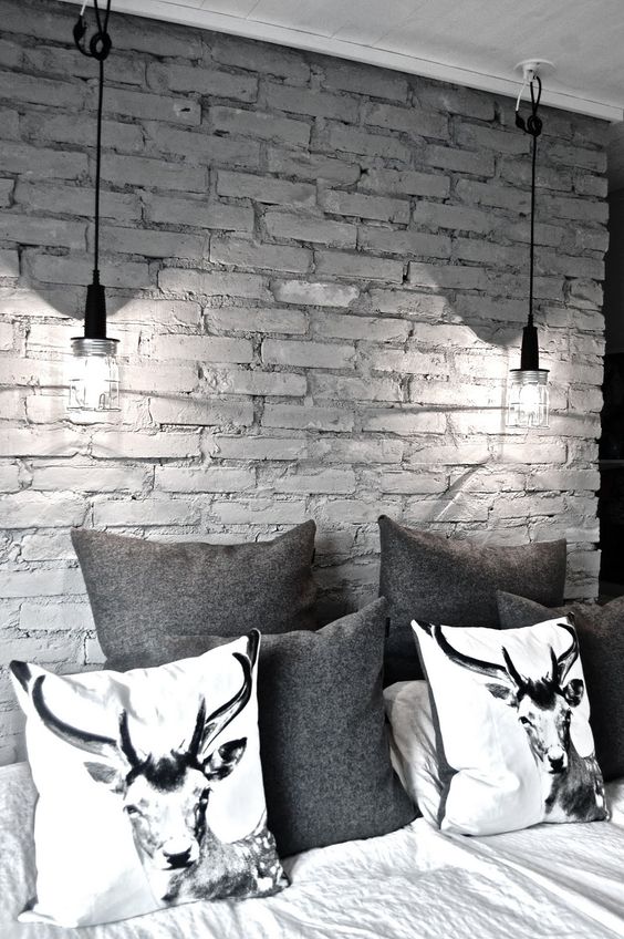 a monochromatic space with a grey brick wall that makes it more interesting