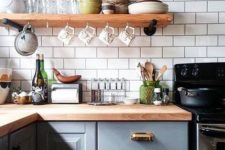19 a grey kitchen with a white tile backsplash and butcher block countertops for a chic look