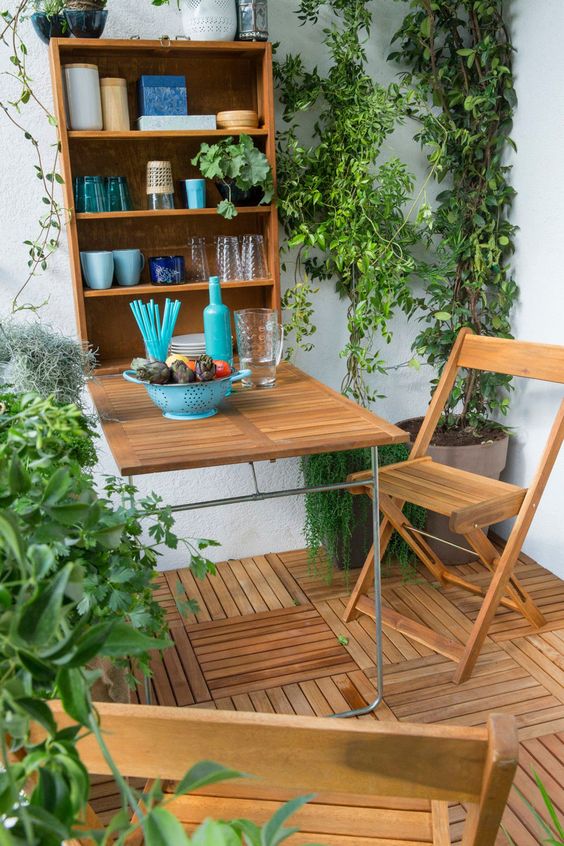 a balcony with a murphy's bar and chairs plus a lot of greenery, you won't need more