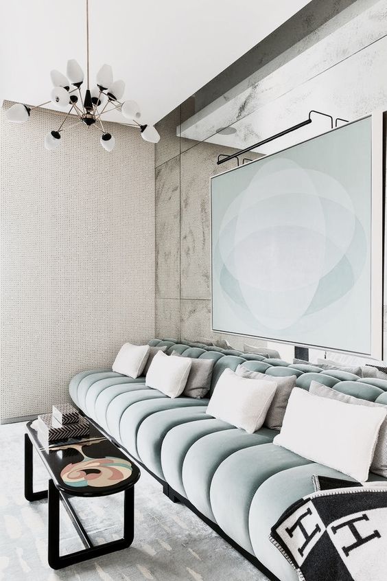 a contemporary TV or cinema room with a luxurious aqua velvet banquette